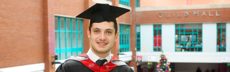 Student outside the preston guild hall with mortarboard receiving his masters degree